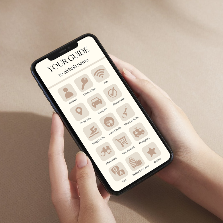 Smartphone displaying a welcome screen for an Airbnb guest guide, placed on a beige fabric background.