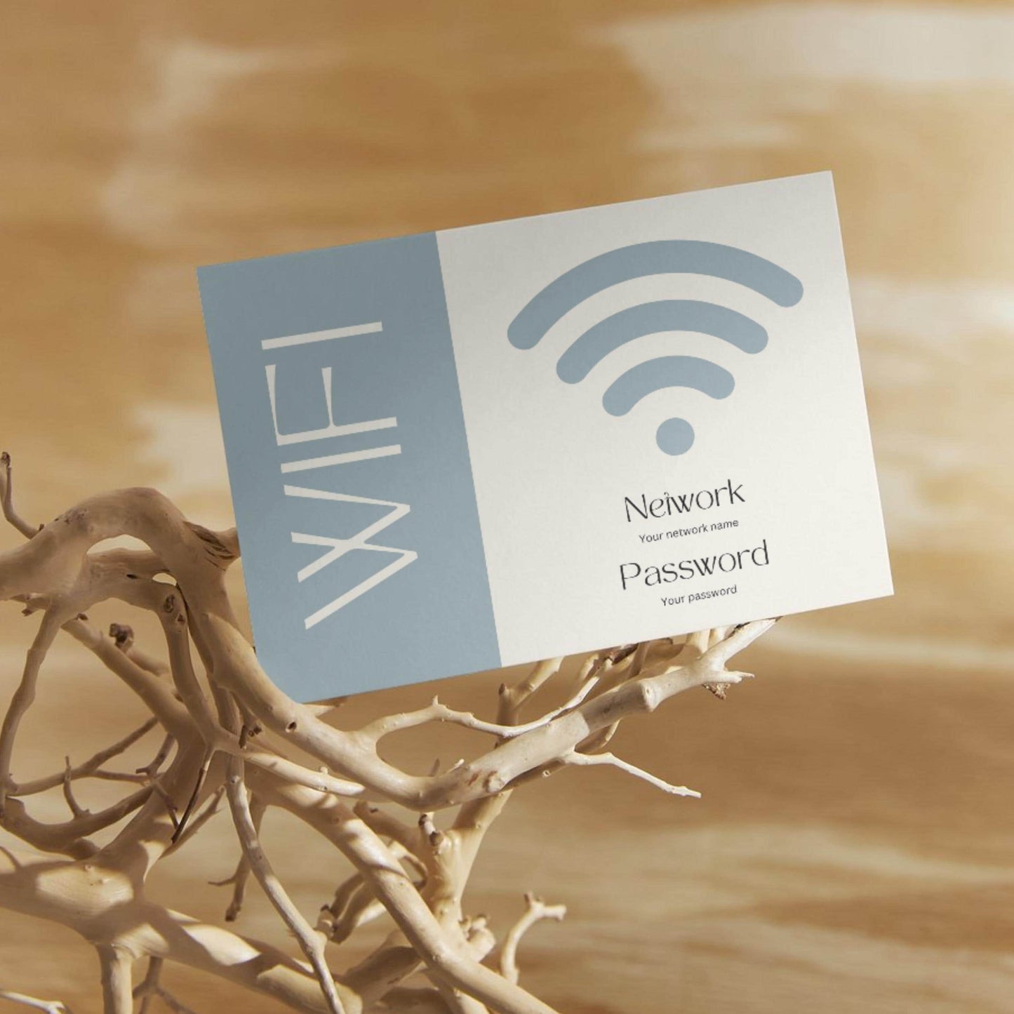 Minimalist WiFi card design, displaying placeholders for network name and password, propped on decorative driftwood against a warm wooden background.