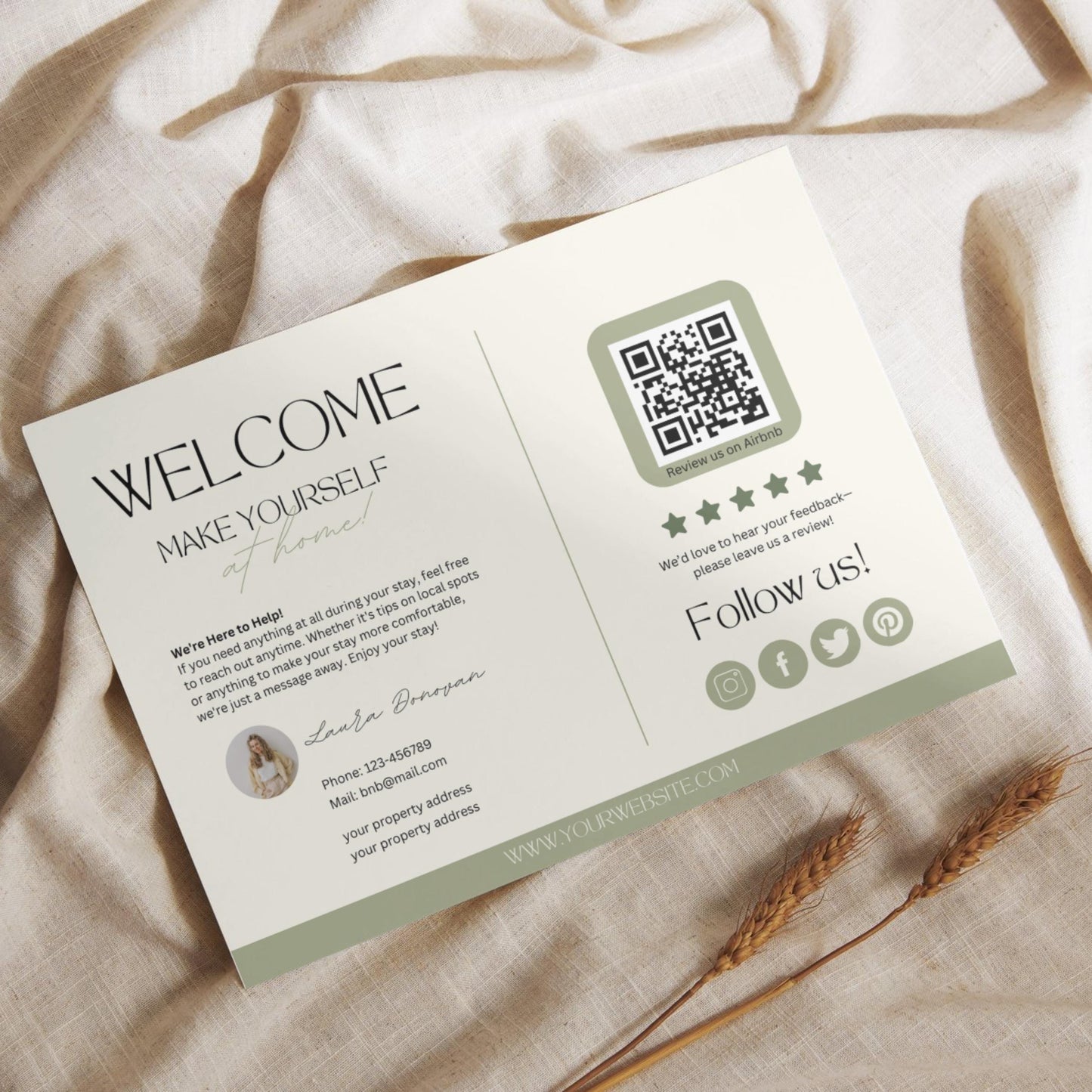 Flat lay of a modern Airbnb welcome card featuring guest information, a QR code for reviews, and social media icons, placed on a light linen fabric with dried wheat stalks.