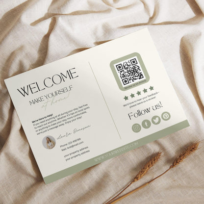 Flat lay of a modern Airbnb welcome card featuring guest information, a QR code for reviews, and social media icons, placed on a light linen fabric with dried wheat stalks.