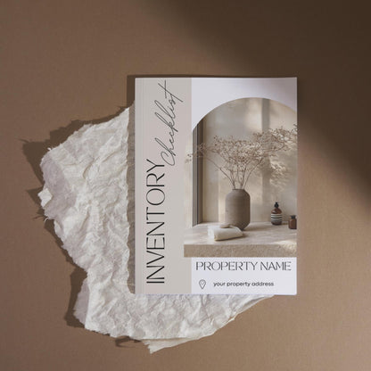 A stylish “Inventory Checklist” booklet is placed on a piece of crumpled white parchment against a warm brown background. The cover features minimalist design elements with soft beige tones and elegant fonts.